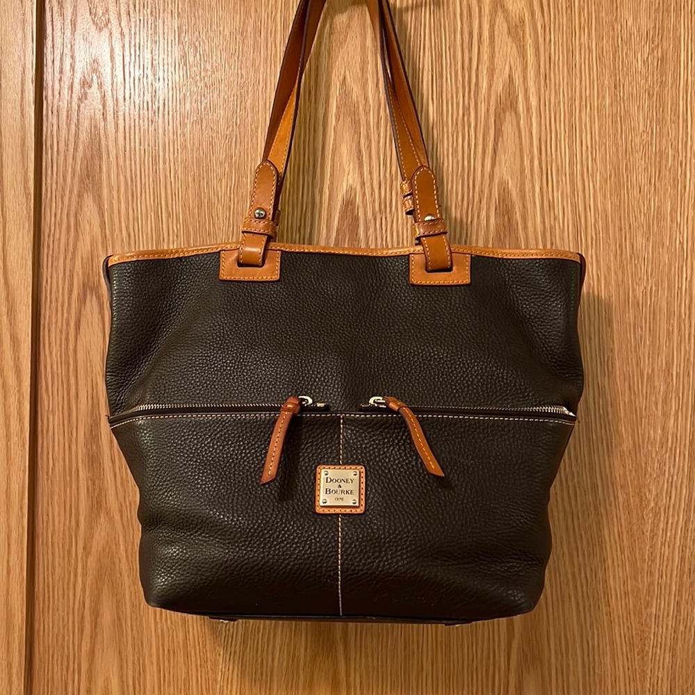 This is a dark brown and natural leather tote